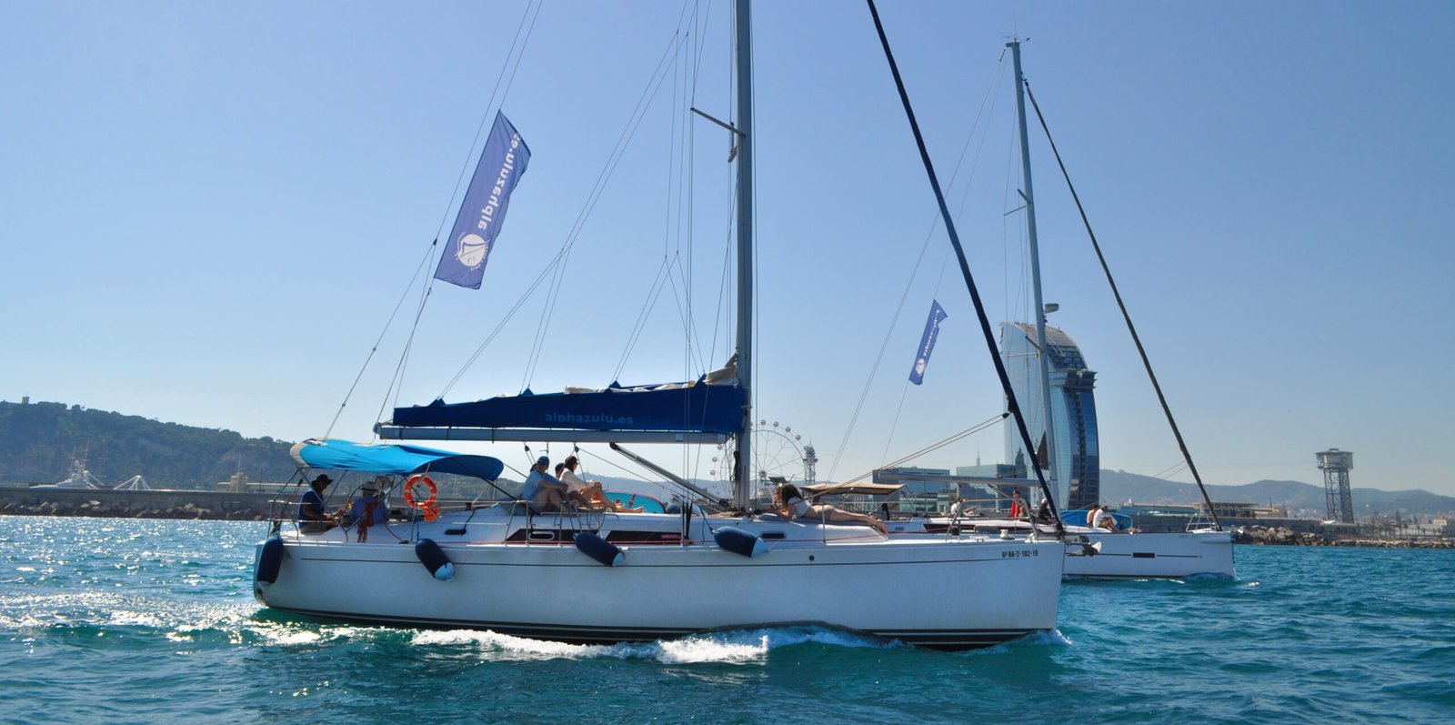 Daily charter in Barcelona with Alpha and Mon Toi sailboats sailing along the coast